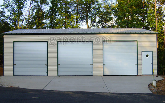 Three roll up garage doors and walk thru door shown on this 30x45x12x16.3 metal garage.