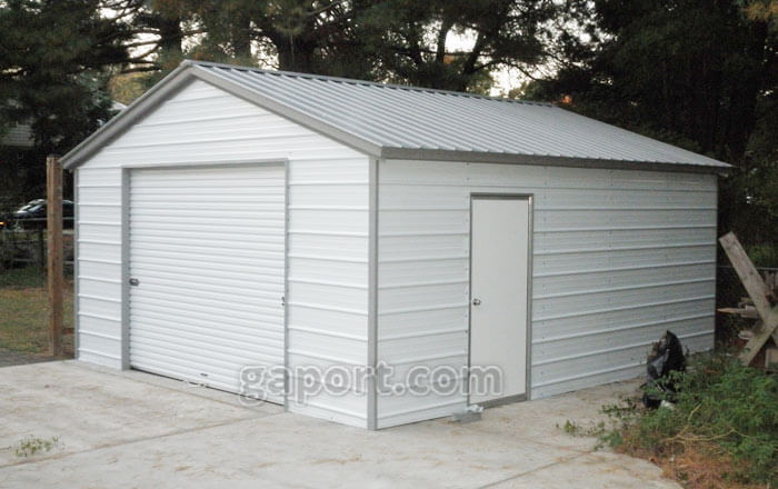 White garage with grey trim, one roll-up garage door on the end and side entry door.
