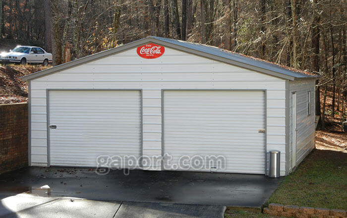 Displaying a 24 by 25 steel two car garage with neutral pewter grey colored siding.