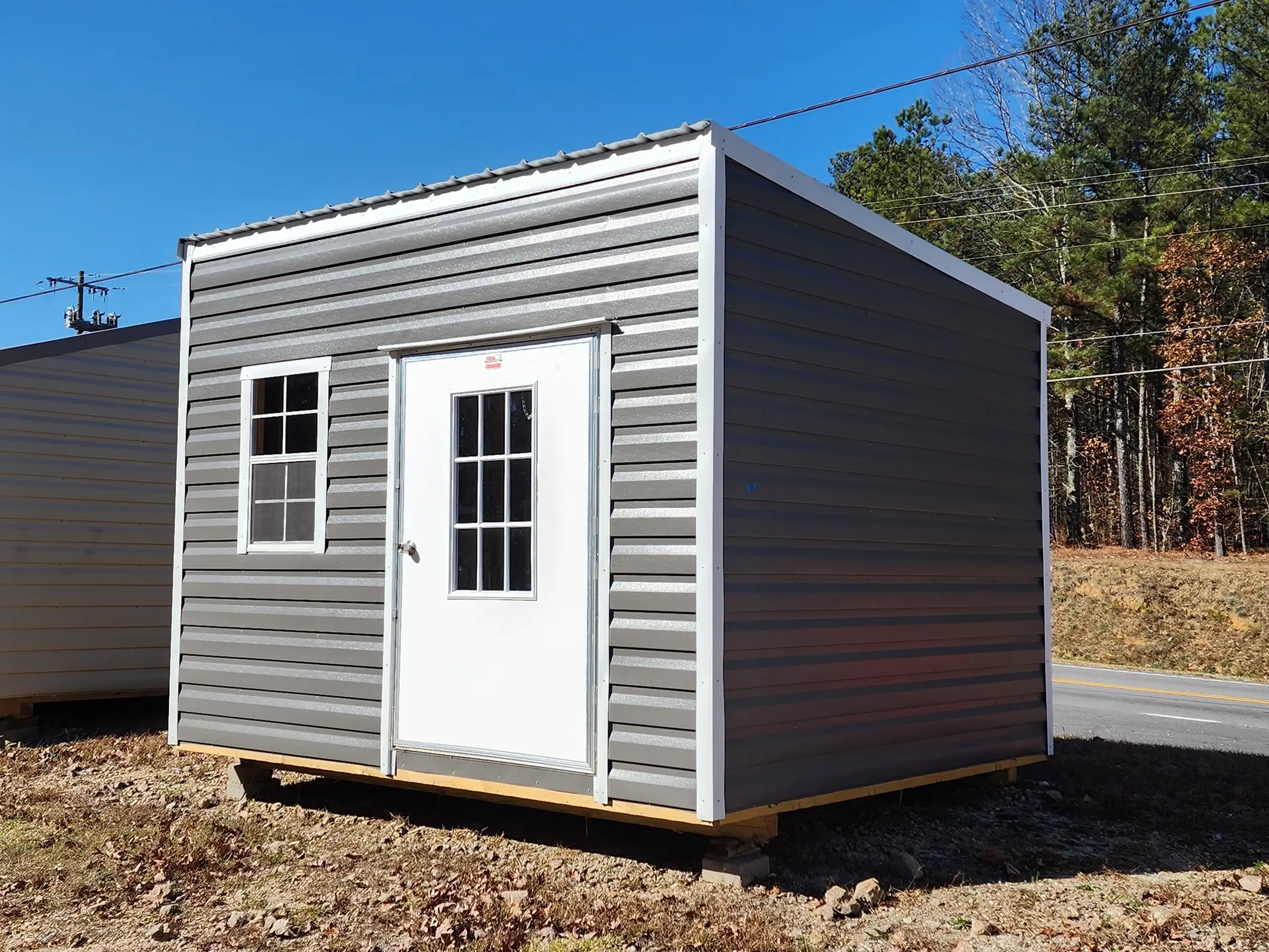 Portable office building in the 10 by 12 size with a modern single sloped roof look.