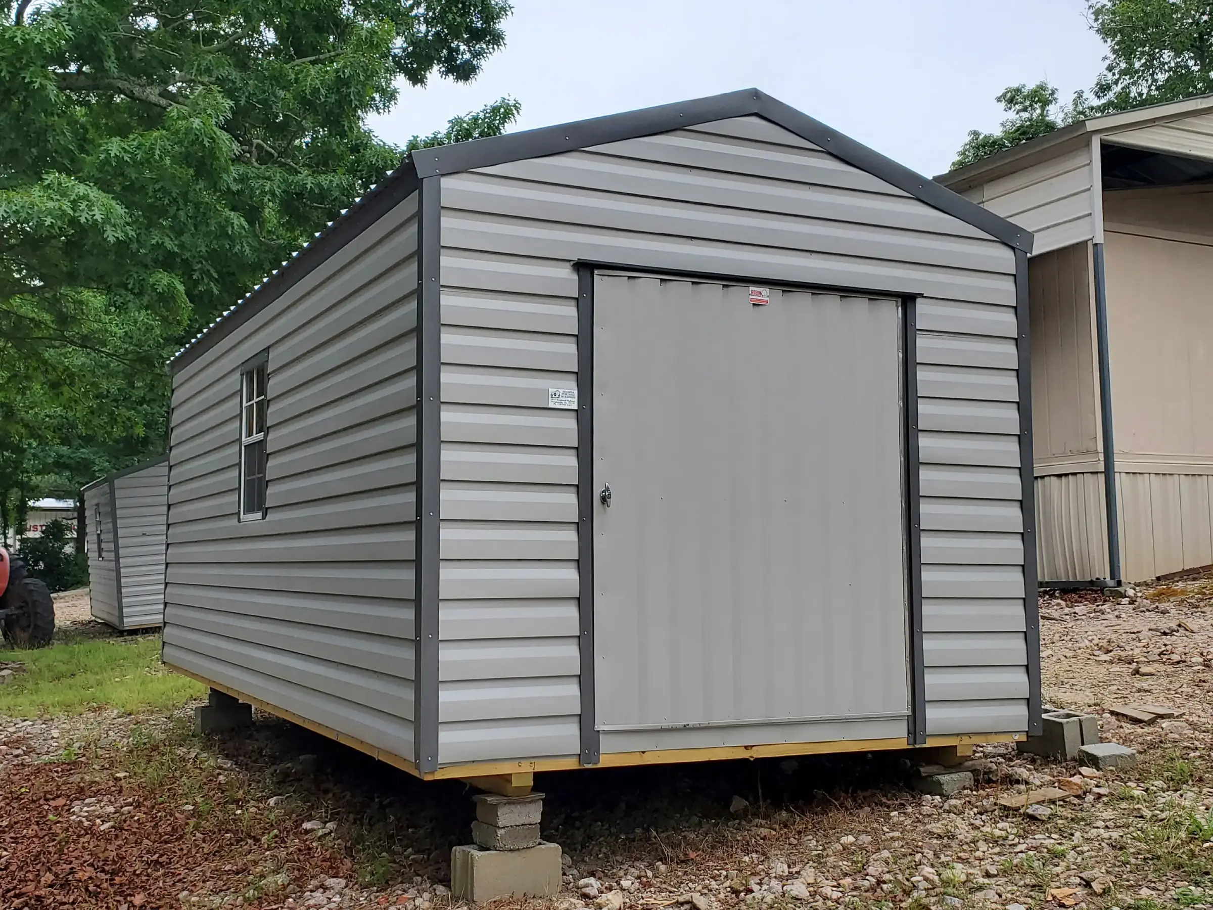 10 ft. by 20 ft. highly functional portable shed building with large end door and two windows.