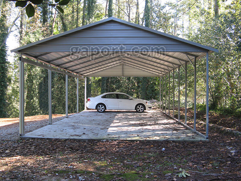 This end view has a white car inside of a side entrance carport with quaker gray roof and gable end.
