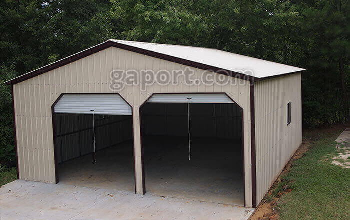 Metal workshop garage for two vehicles, an entry door and room in the back to spare.