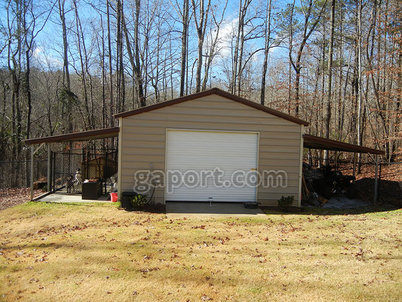Solid metal garage with carport on each side and concrete base, end door. This photo shows a garage with a carport on each side.