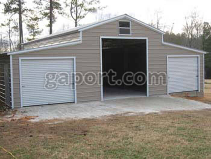 metal barn building with clay colored siding and white trim