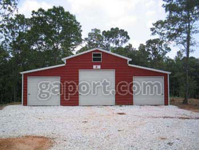 really nice red metal barn with a total of 4 roll-up doors