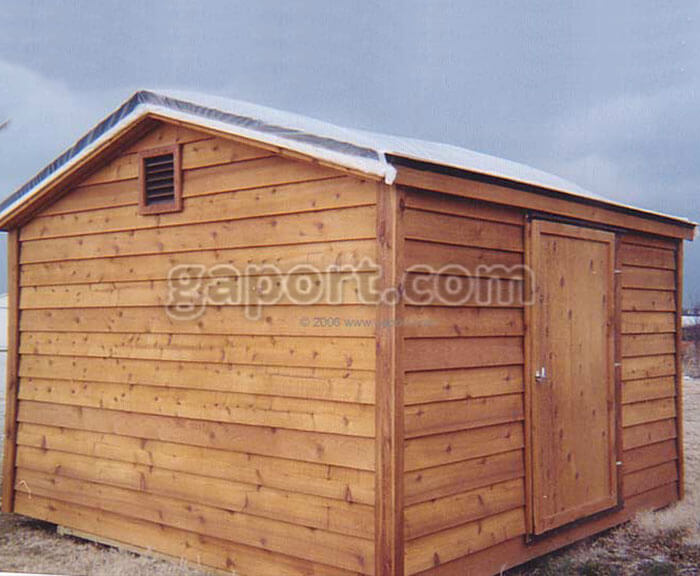 A lovely and solid crafted portable wood storage building with asphalt shingled roof and vent.